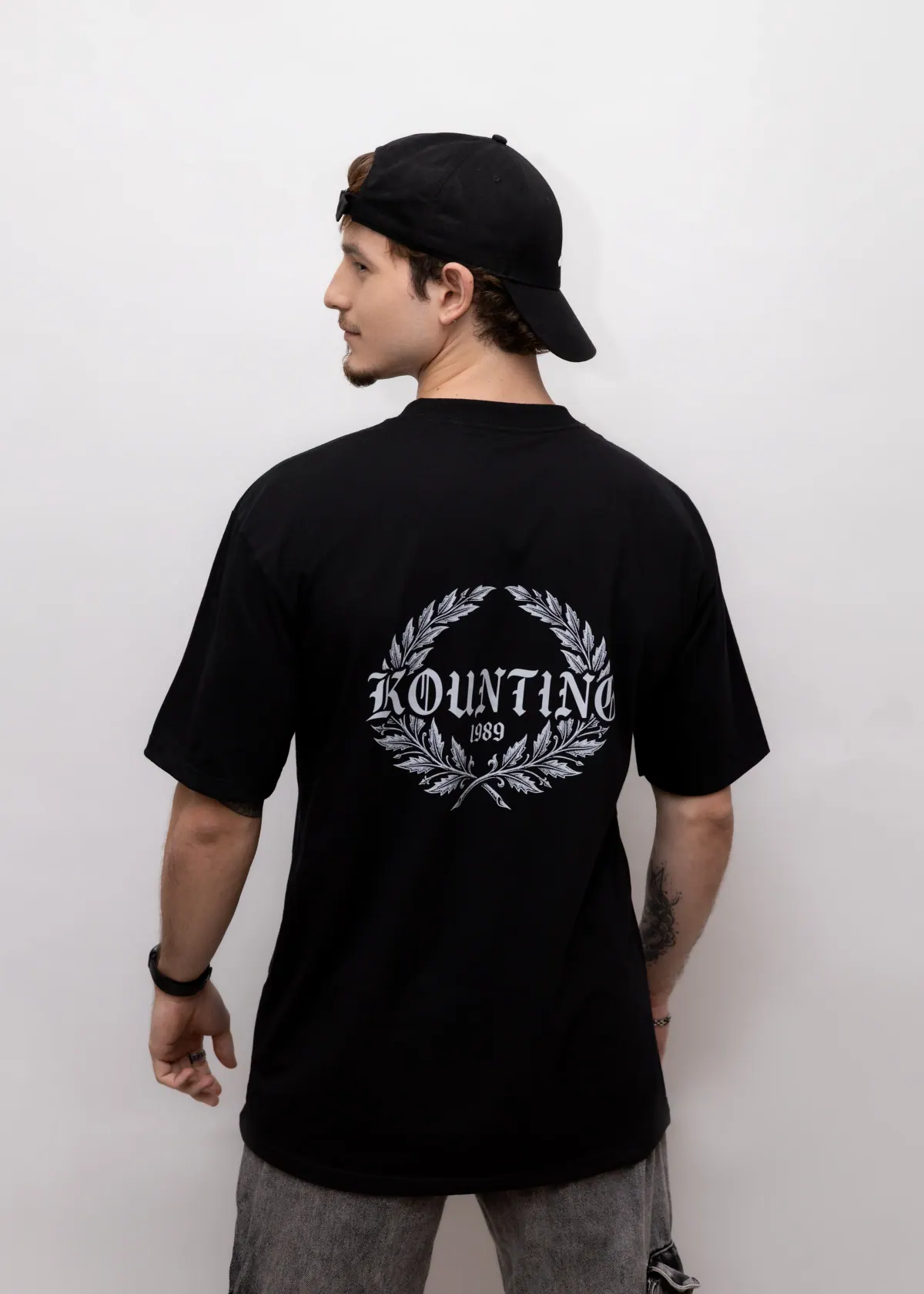 Costas da Camiseta Oversized Essential Emblema preta com emblema da marca